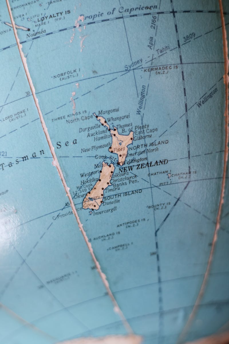 Close-up image of a vintage globe showcasing New Zealand and surrounding oceans.